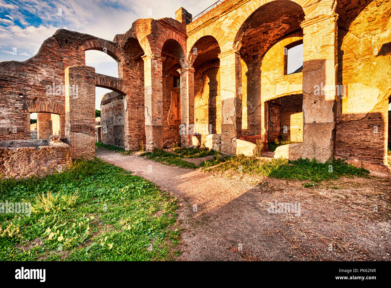 Roman ruins in Ostia Antica with glimpse of the arcades and shops in the block of Serapide - Rome Stock Photo