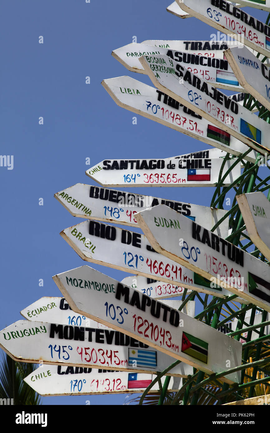 Signpost to Tirana Asuncion Sarajevo Santiago de Chile Kartun Maputo at Puerto Lopez Beach in Ecuador Stock Photo