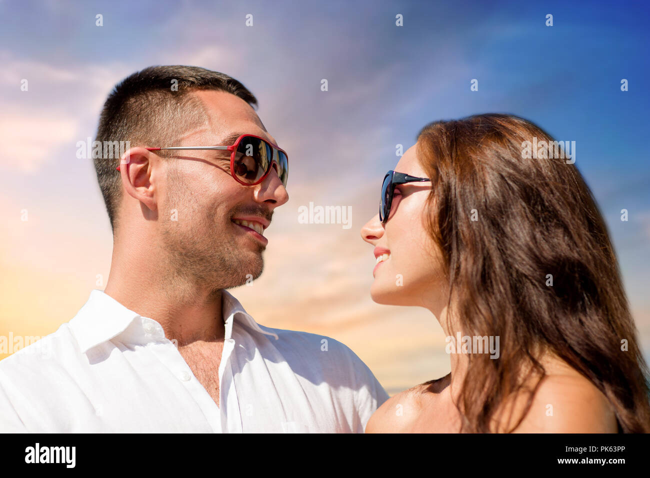 happy couple in sunglasses over sky background Stock Photo - Alamy
