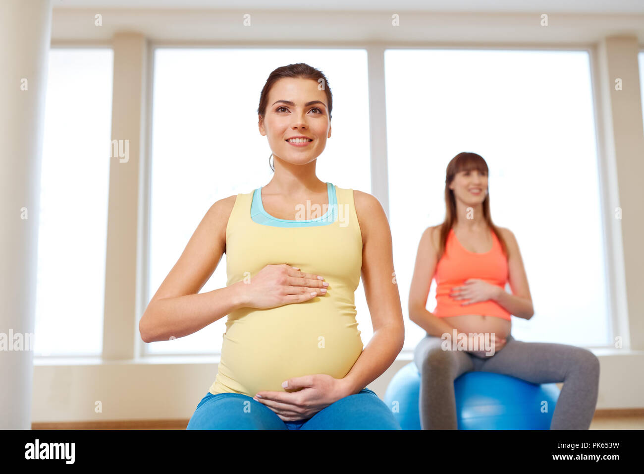 pregnant women sitting on exercise balls in gym Stock Photo Alamy