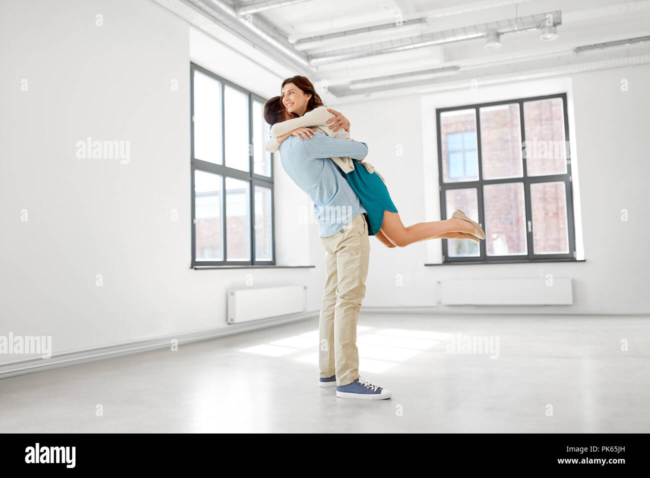 happy couple hugging at new home Stock Photo - Alamy