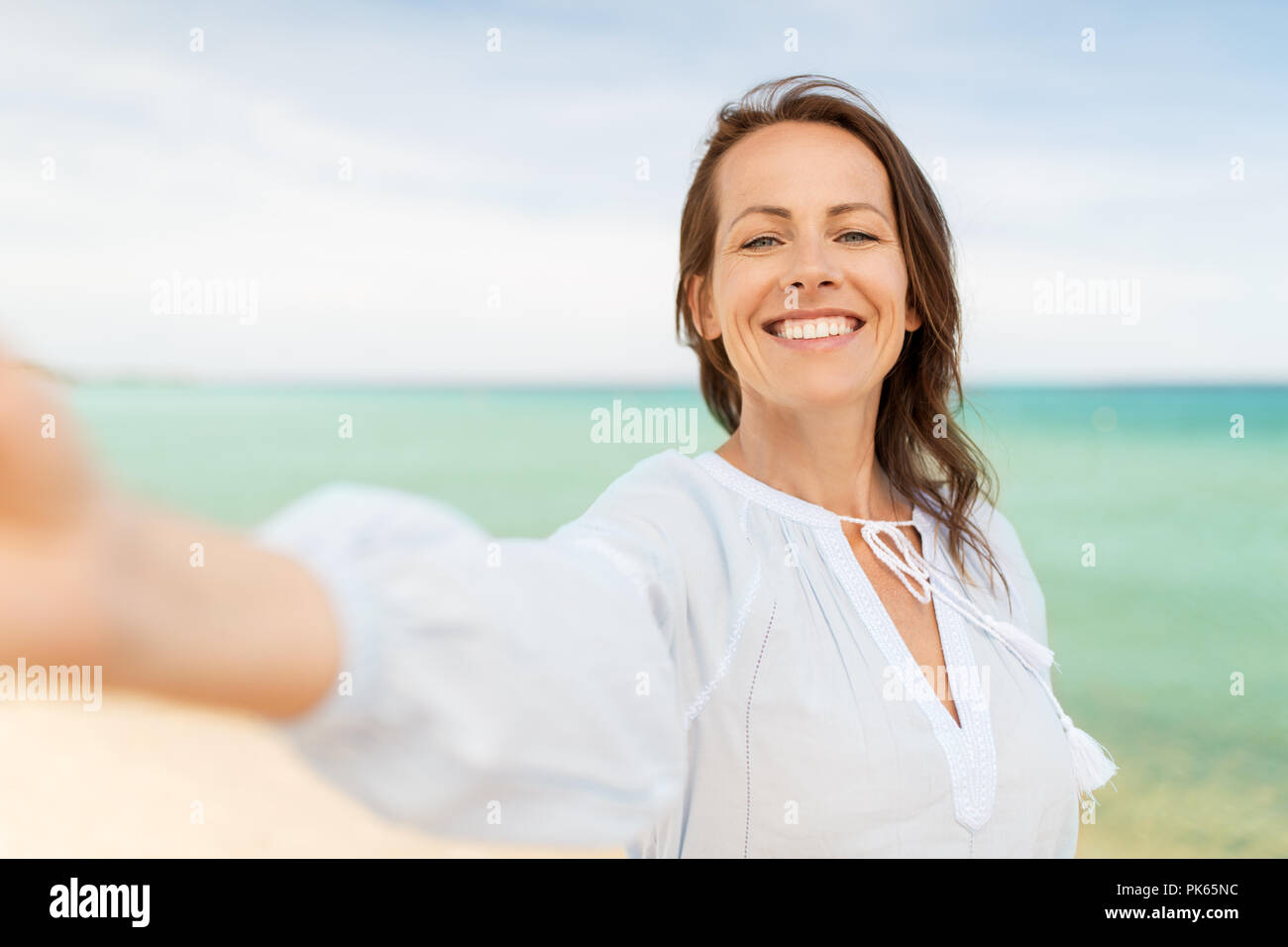 happy smiling woman taking selfie on summer beach Stock Photo - Alamy