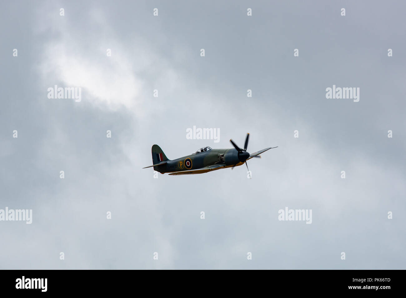 A Hawker Sea Fury carrier borne fighter-bomber of the Fleet Air Arm climbs into a threatening sky Stock Photo