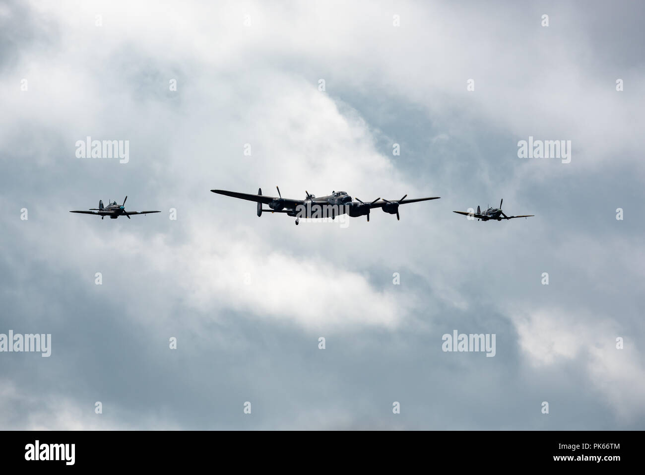 An Avro Lancaster PA474 of the Battle of Britain Memorial Flight  with accompanying Supermarine Spitfire and Hawker Hurricane Stock Photo