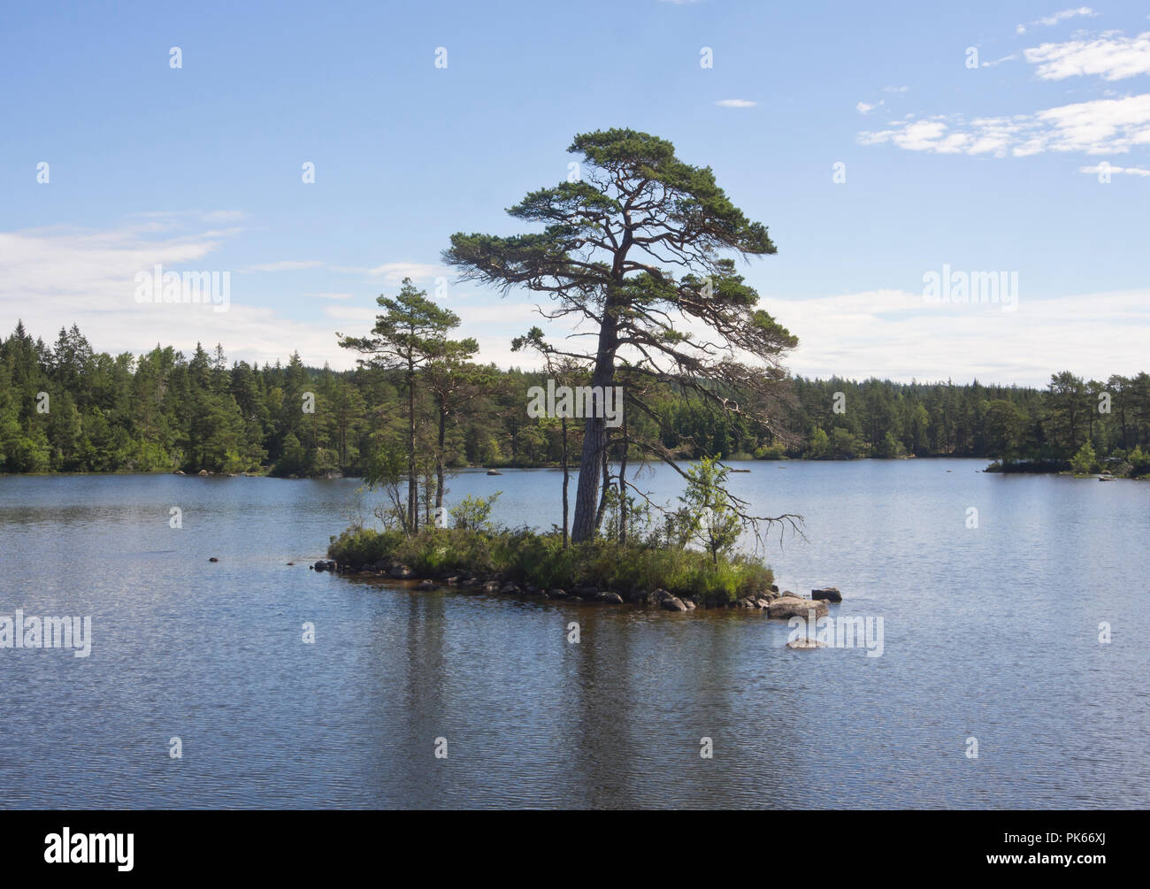 Crossing the Viken lake on the Göta canal, boat cruise along an idyllic waterway in Sweden Stock Photo