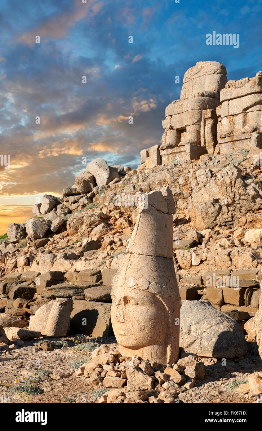 Statue head at sunrise of Apollo in front of the stone pyramid 62 BC Royal Tomb of King Antiochus I Theos of Commagene, east Terrace, Mount Nemrut or  Stock Photo
