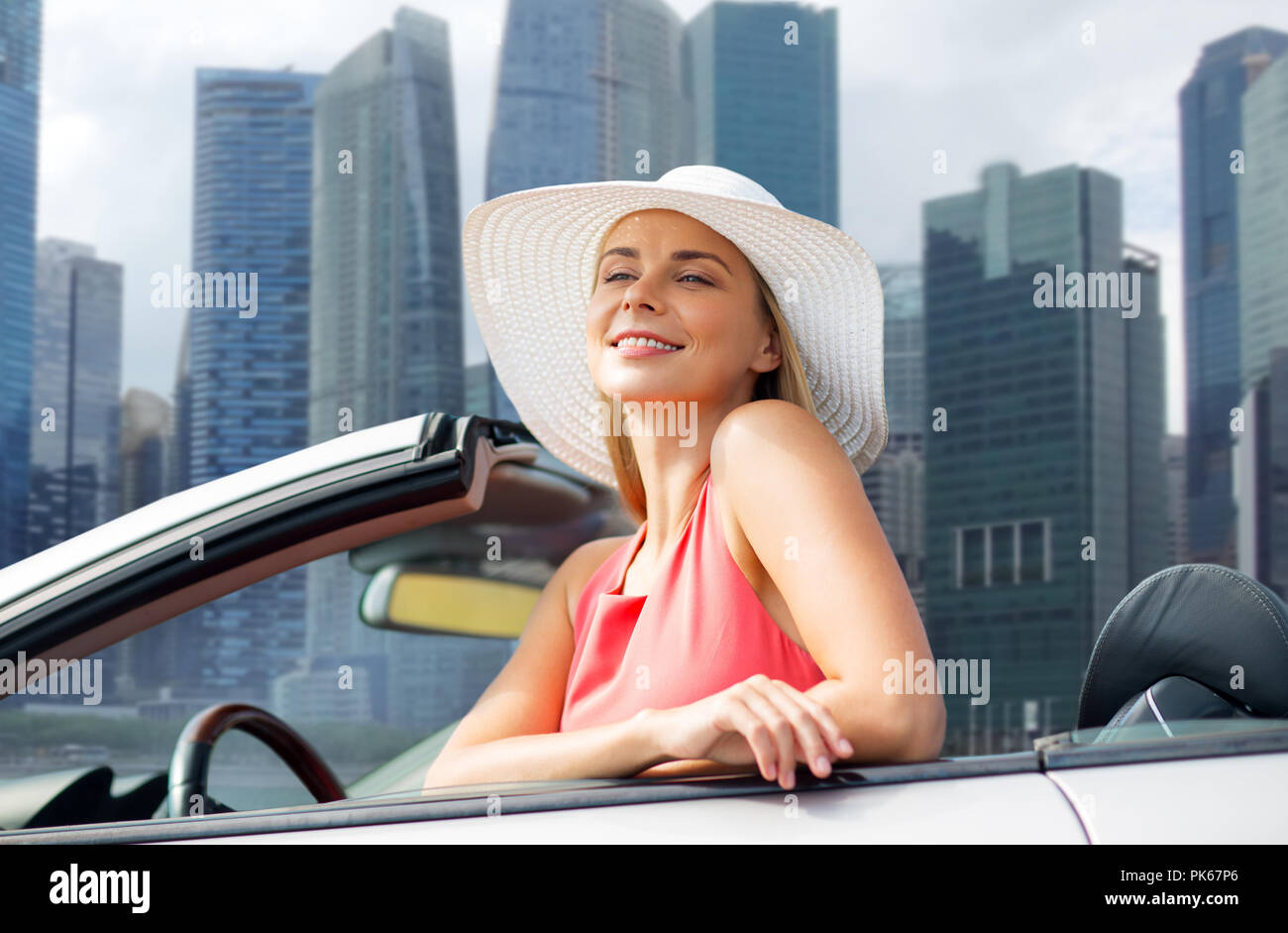 woman in hat in convertible car over singapore Stock Photo Alamy