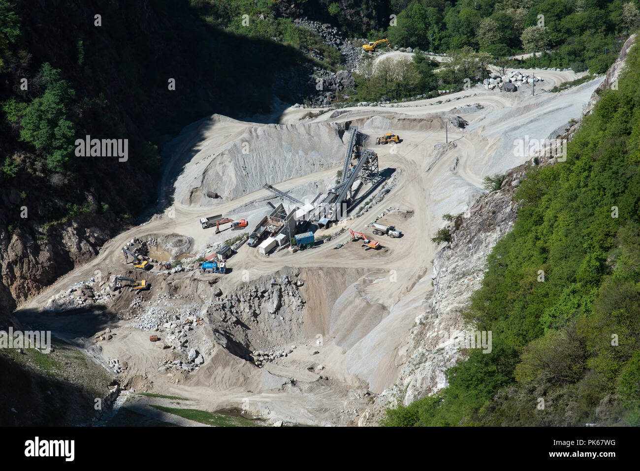 View of opencast mining quarry with  machinery at work Stock Photo