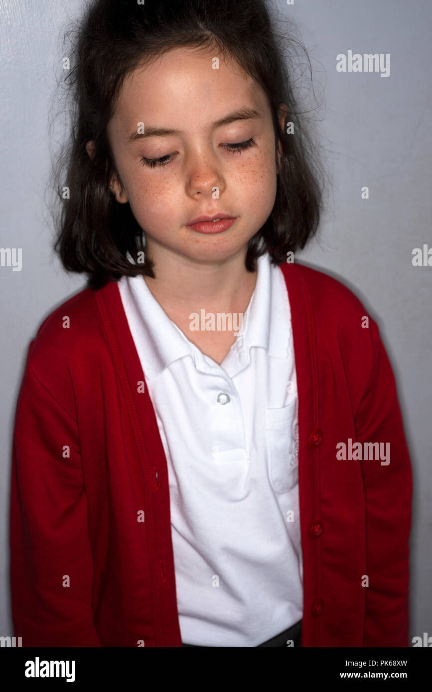 Schoolgirl unhappy to be going back to school after the summer holiday Stock Photo