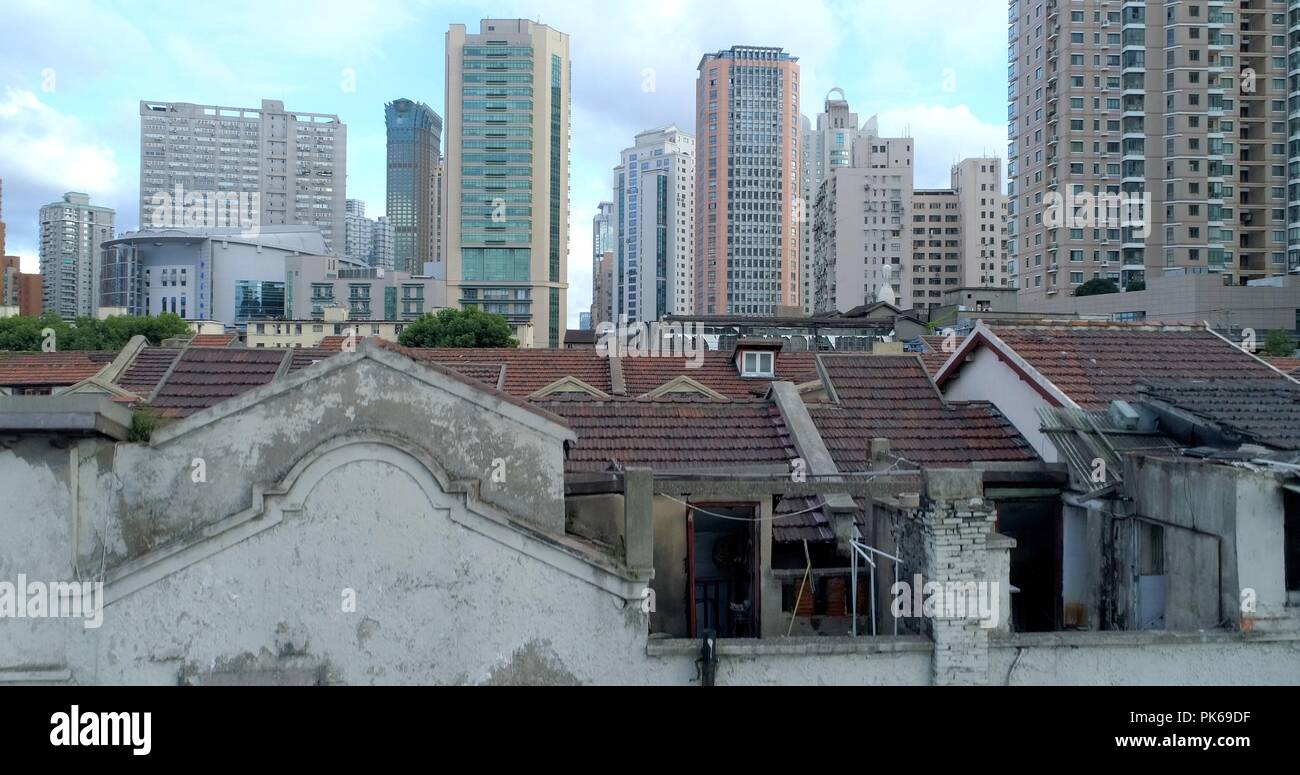 One of the very few remaining old Shanghai style residential areas (foreground) shortly before its demolition. 08.19.2018. Shanghai, China. Stock Photo