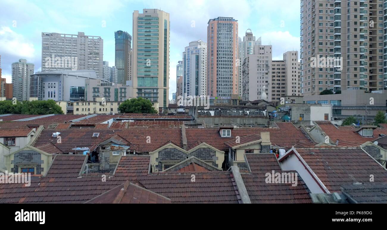 One of the very few remaining old Shanghai style residential areas (foreground) shortly before its demolition. 08.19.2018. Shanghai, China. Stock Photo