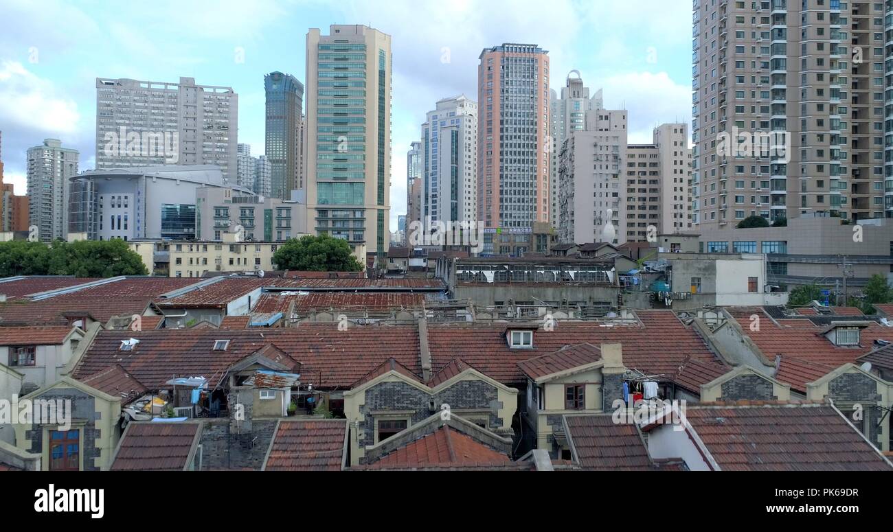 One of the very few remaining old Shanghai style residential areas (foreground) shortly before its demolition. 08.19.2018. Shanghai, China. Stock Photo