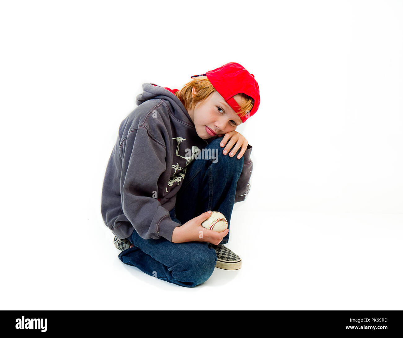 Young boy in baseball cap posing, isolated on white background Stock