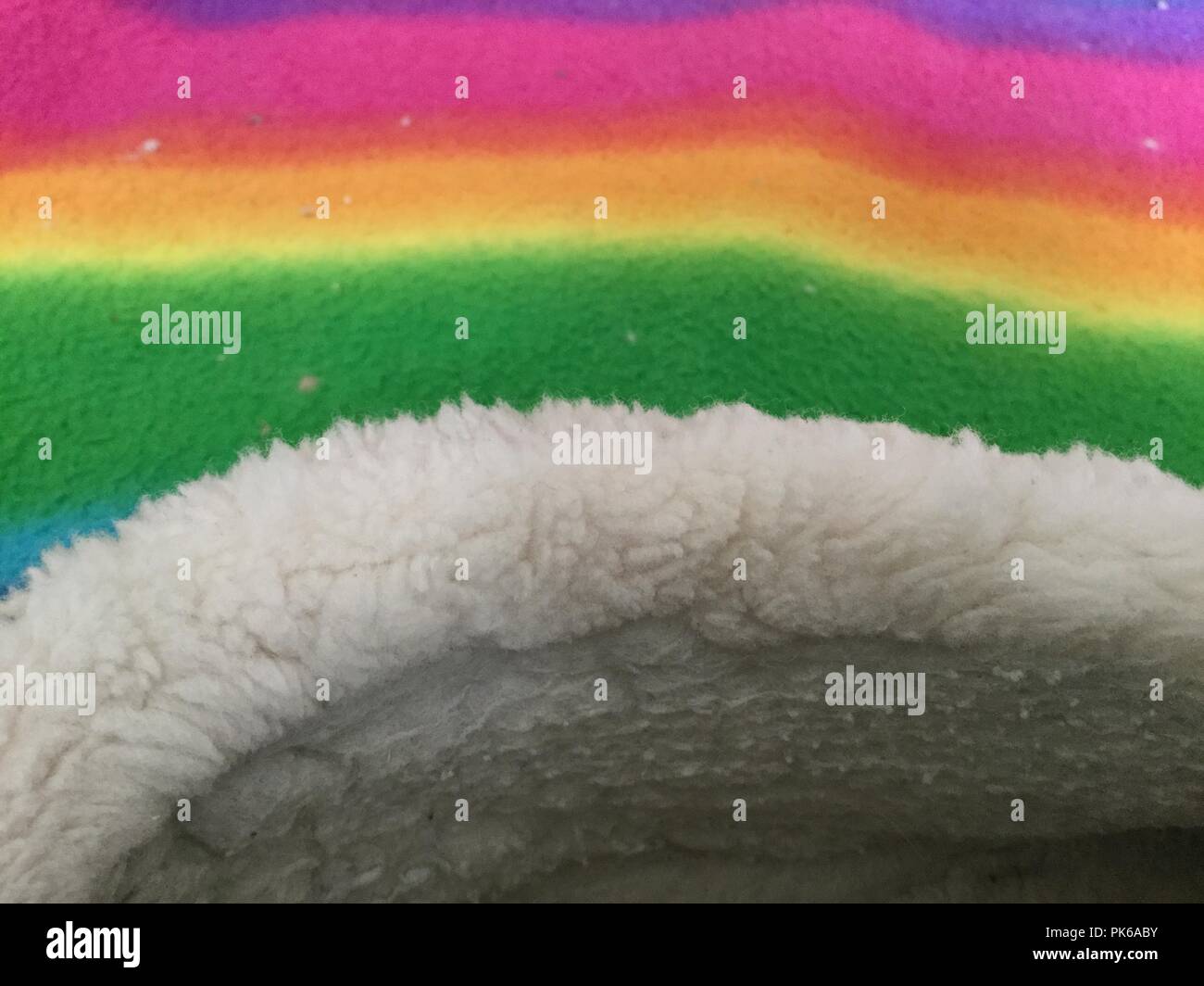 Soft furry fabric on multicolored background. Stock Photo