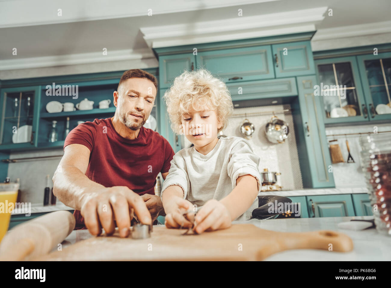 Father and son taking baking tins making cookies for breakfast Stock ...