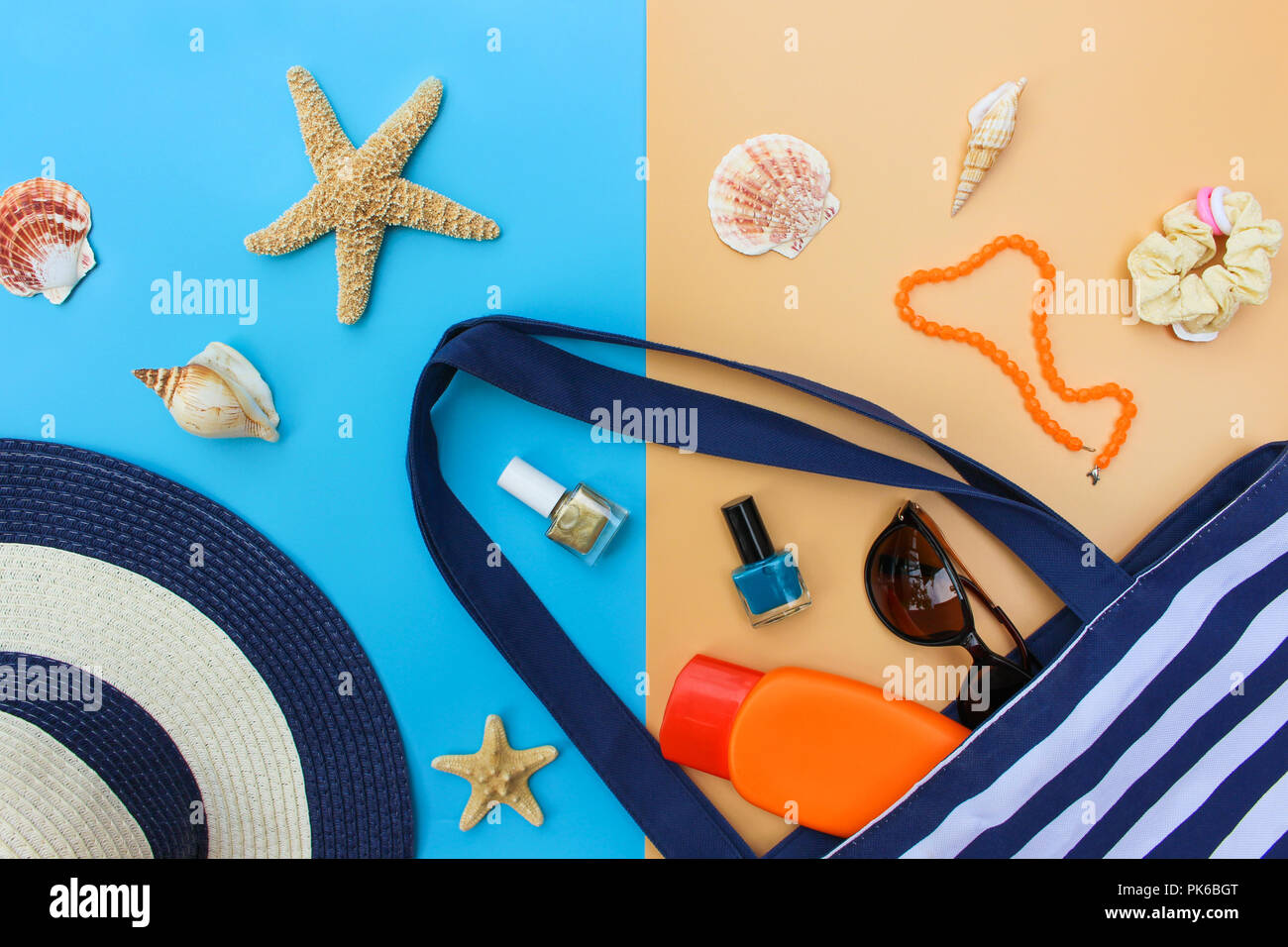 Beach bag, sun hat, sunblock, beads, shells, sunglasses, hair scrunchies, nail polish. Top view. Stock Photo