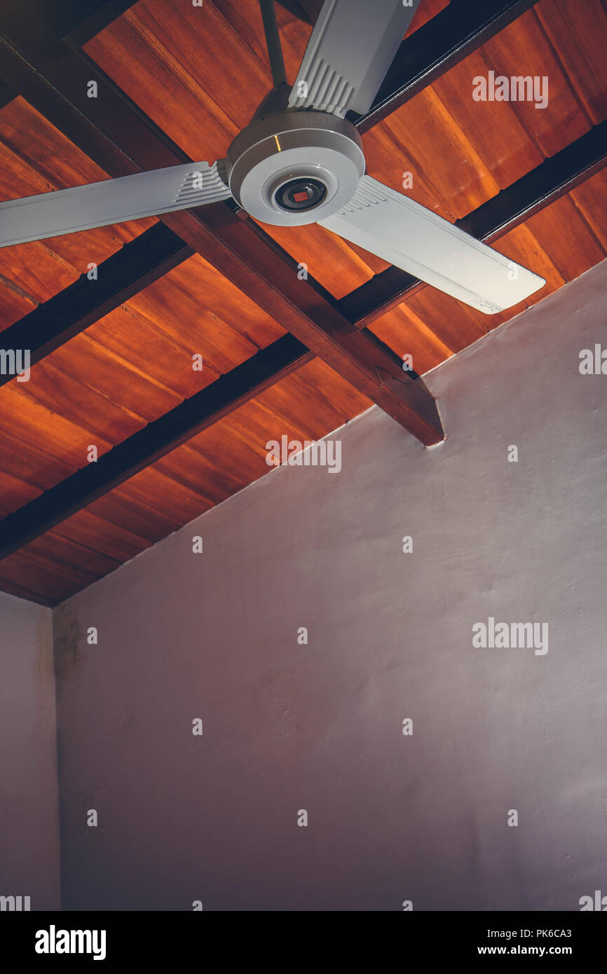 Ceiling fan on the background of a brown wooden ceiling Stock Photo - Alamy