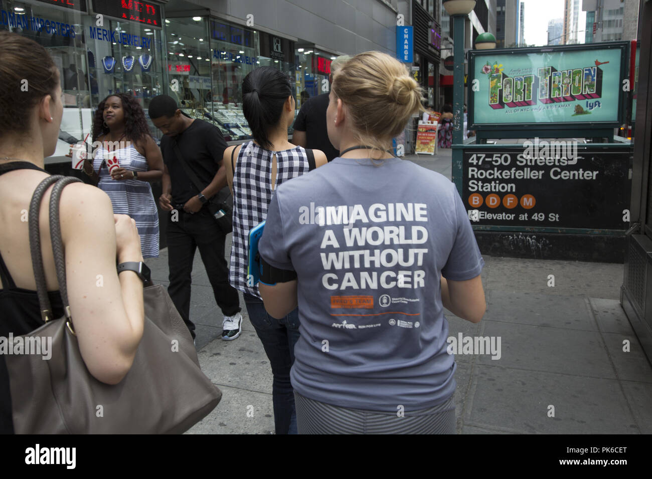 Woman with tshirt supporting Cancer research on the street in midtown