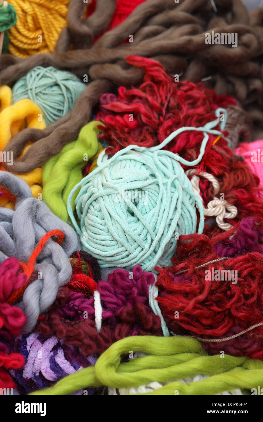 mass of woven weaving material. large bundle of fluffy thick twine and yarn wool. Lots of colour. Knitting and sewing concept. wool all tangled up. Stock Photo