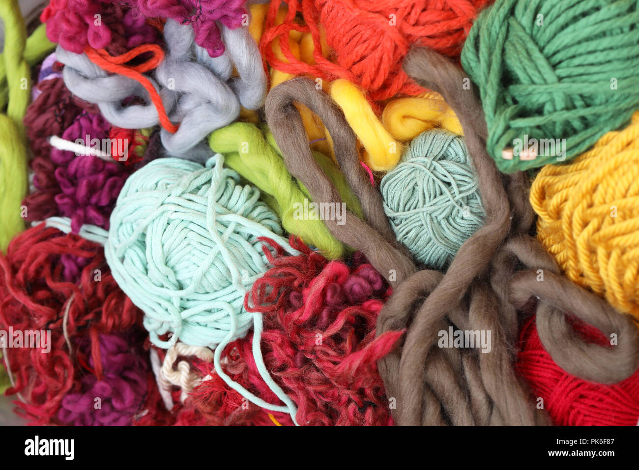 mass of woven weaving material. large bundle of fluffy thick twine and yarn  wool. Lots of colour. Knitting and sewing concept. wool all tangled up  Stock Photo - Alamy