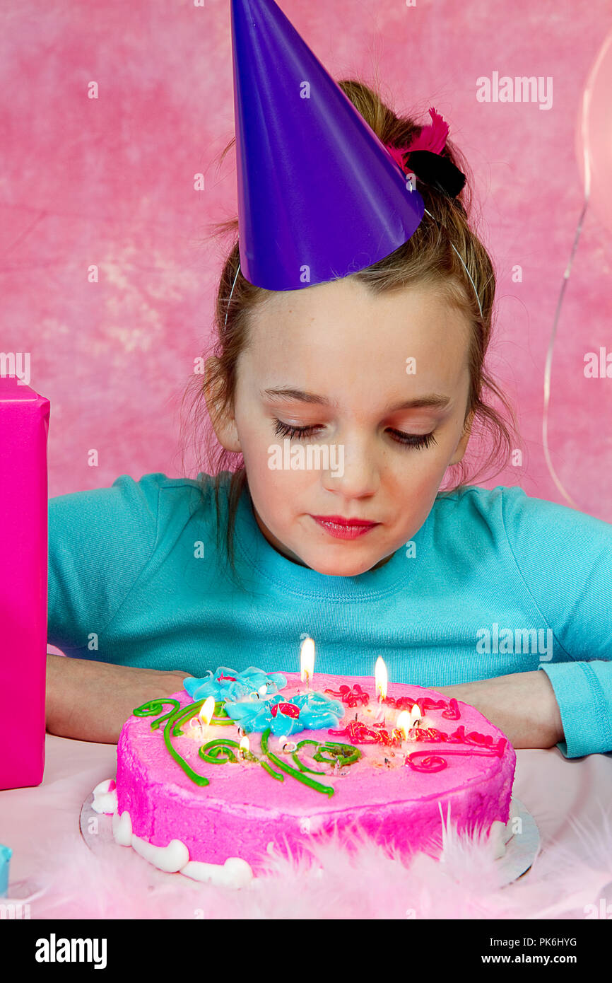 Two beautiful young preteen girls celebrating at a birthday party. Pink and  Aqua balloons and decorations including cake. Gifts and girls having fun  Stock Photo - Alamy