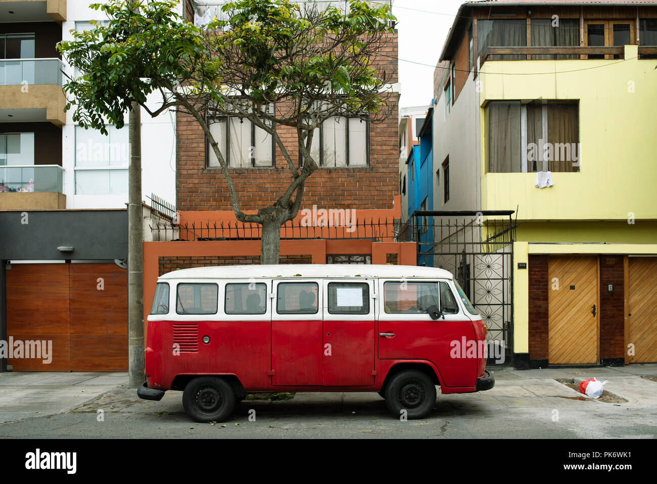 Vintage camper van parking outside residential buildings in Miraflores. Colourful urban scene in Lima, Peru. Jul 2018 Stock Photo