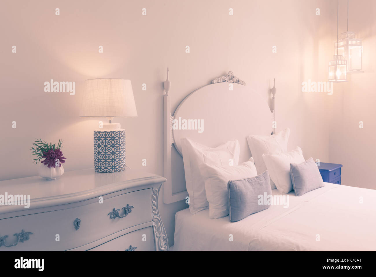 Elegant fancy white bedroom with double bed, lamp, flower Stock Photo Alamy