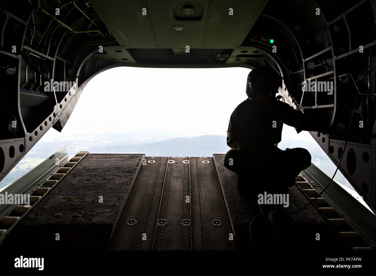 Ojojihara, Miyagi, Japan. 10th Sep, 2018. A crew member of the Japan Self Defense Force monitors the flight with the ramp down on the Japanese CH-47 Chinook during Orient Shield 2018. The objectives of OS 18 include training U.S. ground forces for deployment to Japan in the event of contingencies; exercising Japan Ground Self Defense Force and U.S. Army capabilities for the defense of Japan; preparing U.S. forces for combined, multinational and joint full - spectrum tactical operations; and increasing interoperability between U.S. forces and JGSDF. (U.S. Army Photo by Public Affairs Broa Stock Photo