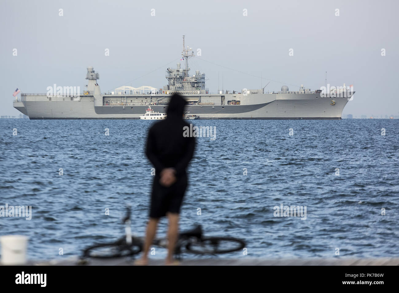 September 10, 2018 - Thessaloniki, Greece - A man watches from the seafront of the city the USS Mount Whitney. USS Mount Whitney LCC-20 visits the northern Greek city of Thessaloniki during Thessaloniki International Trade Fair 2018, where USA participates as the honoured country this year. (Credit Image: © Giannis Papanikos/ZUMA Wire) Stock Photo