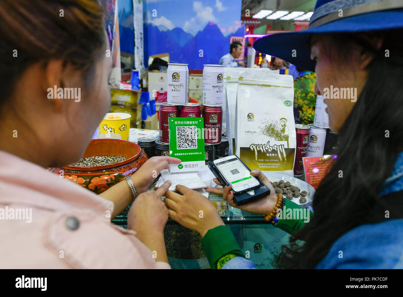 Lhasa, China's Tibet Autonomous Region. 10th Sep, 2018. Visitors pay bills by scanning the QR code at the Fourth China Tibet Tourism and Culture Expo in Lhasa, capital of southwest China's Tibet Autonomous Region, Sept. 10, 2018. Credit: Liu Dongjun/Xinhua/Alamy Live News Stock Photo