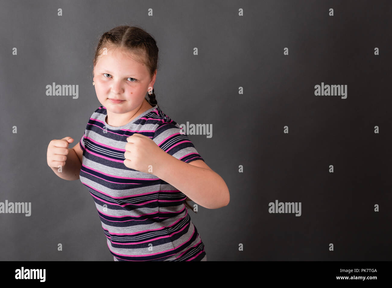 Strong stout girl in an attacking boxing rack Stock Photo