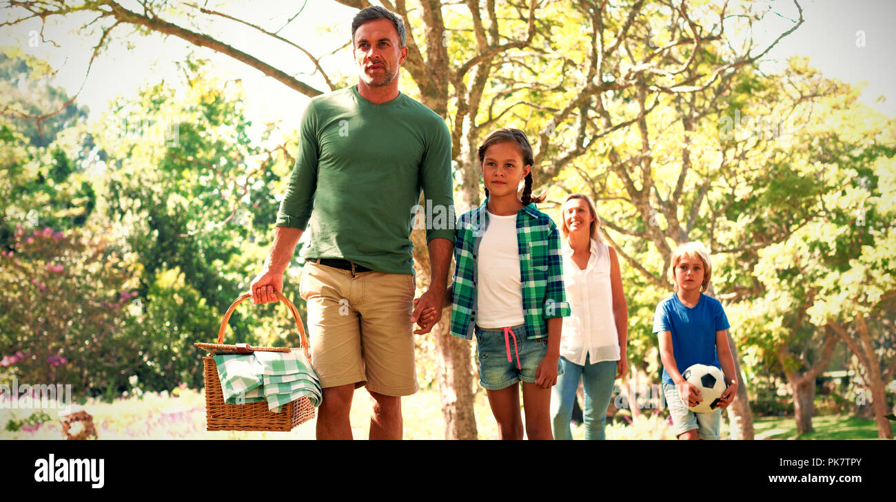 Family arriving in the park for picnic Stock Photo