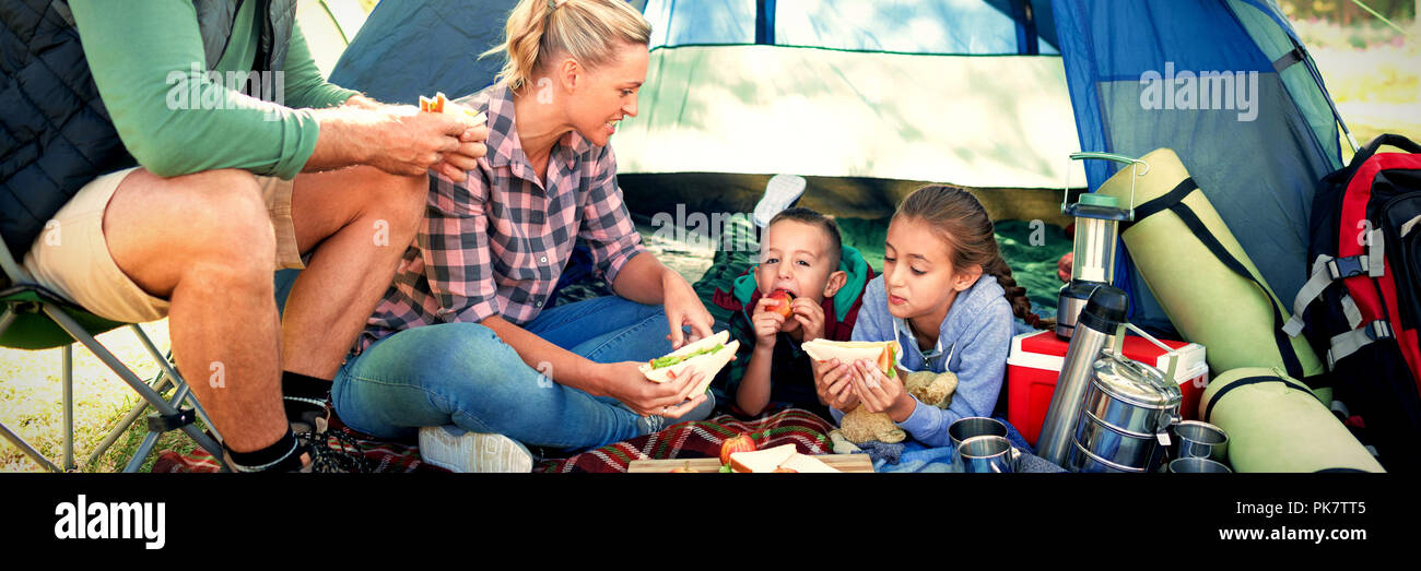 Family having snacks outside the tent Stock Photo