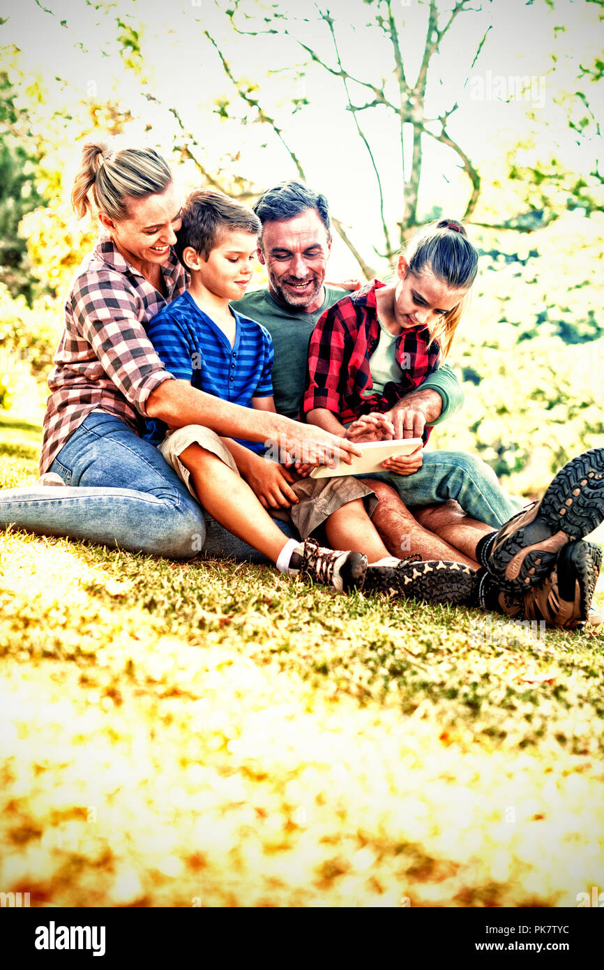 Family using digital tablet in the park Stock Photo