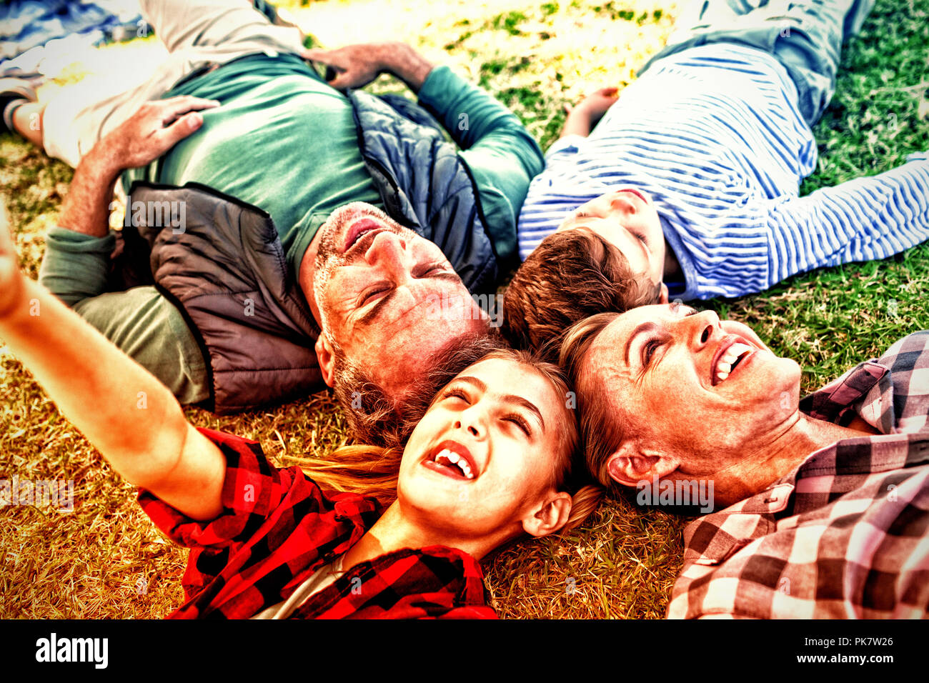 Happy family lying on the grass Stock Photo