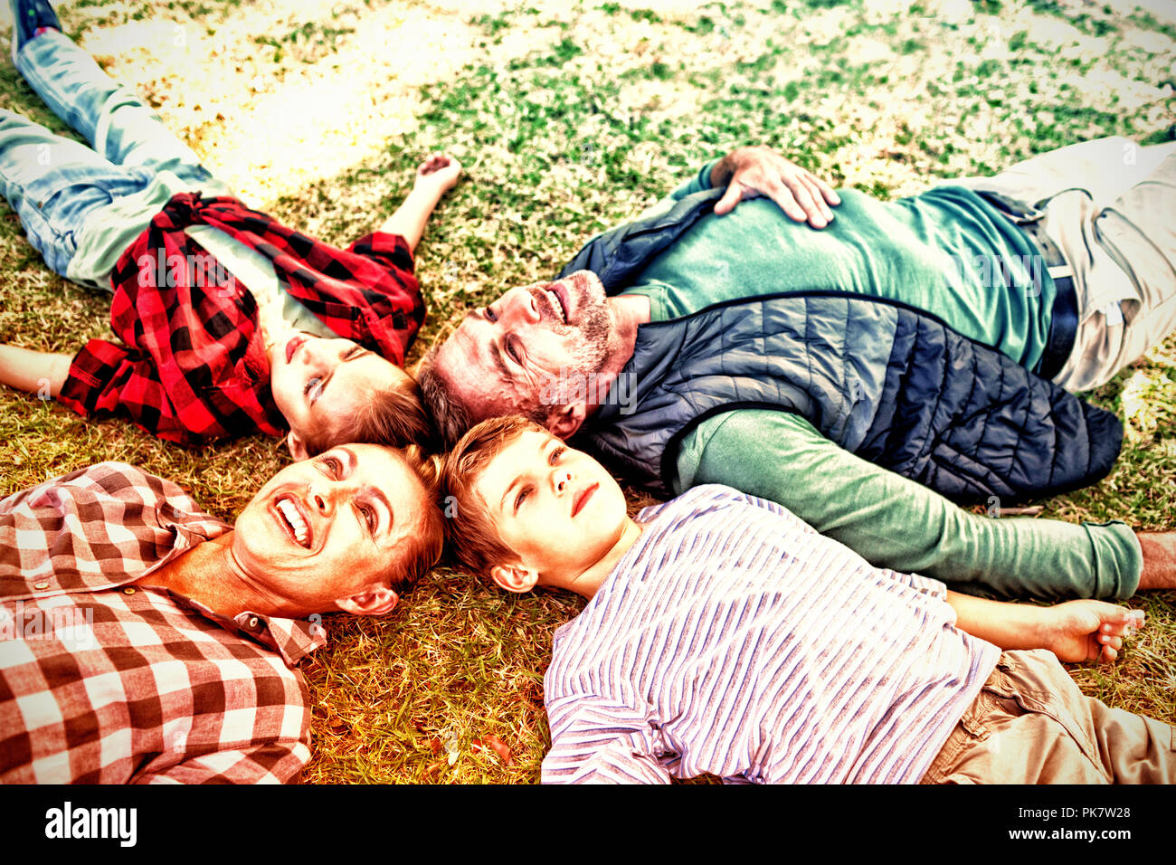 Happy family lying on the grass Stock Photo