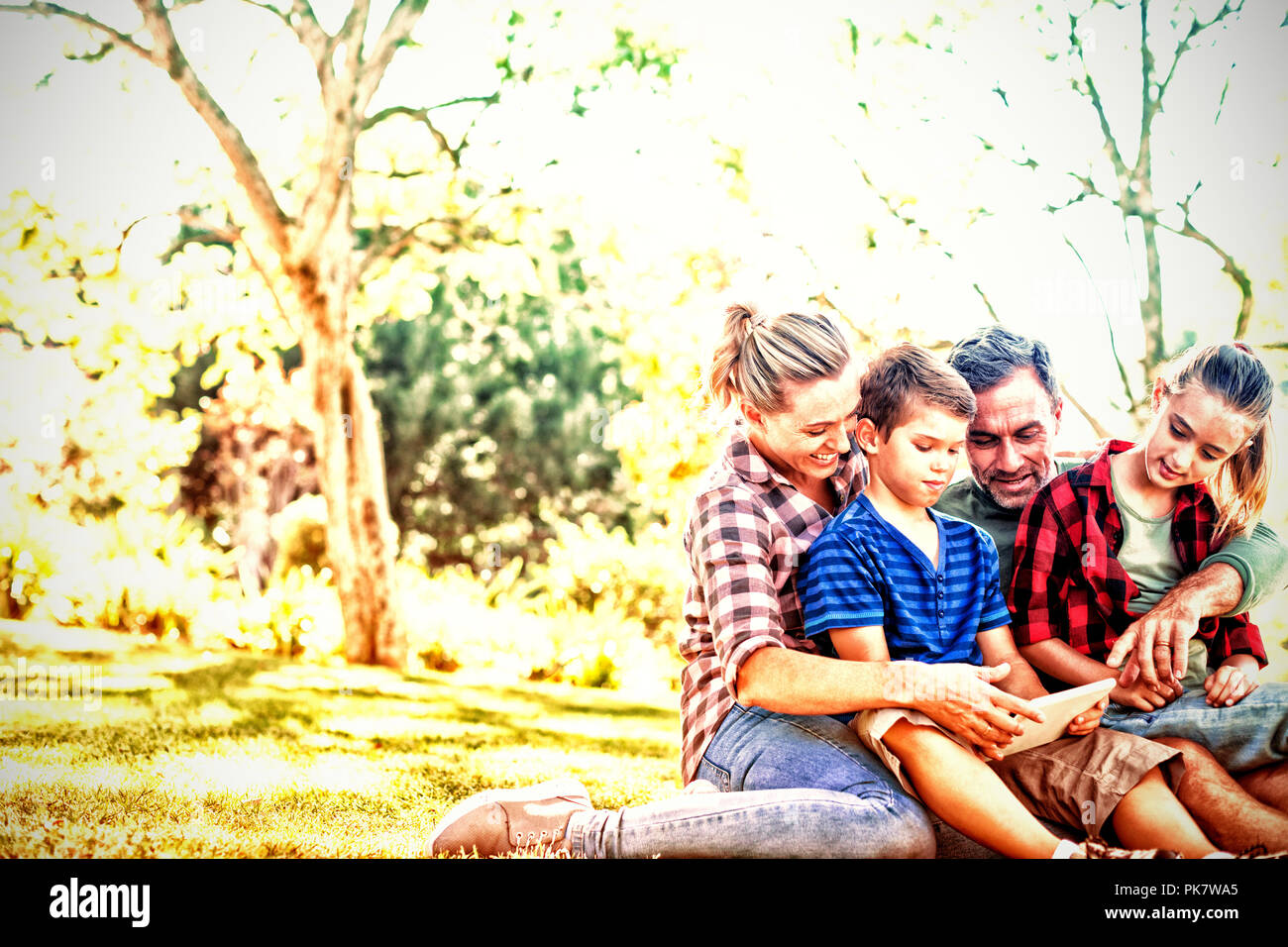 Family using digital tablet in the park Stock Photo