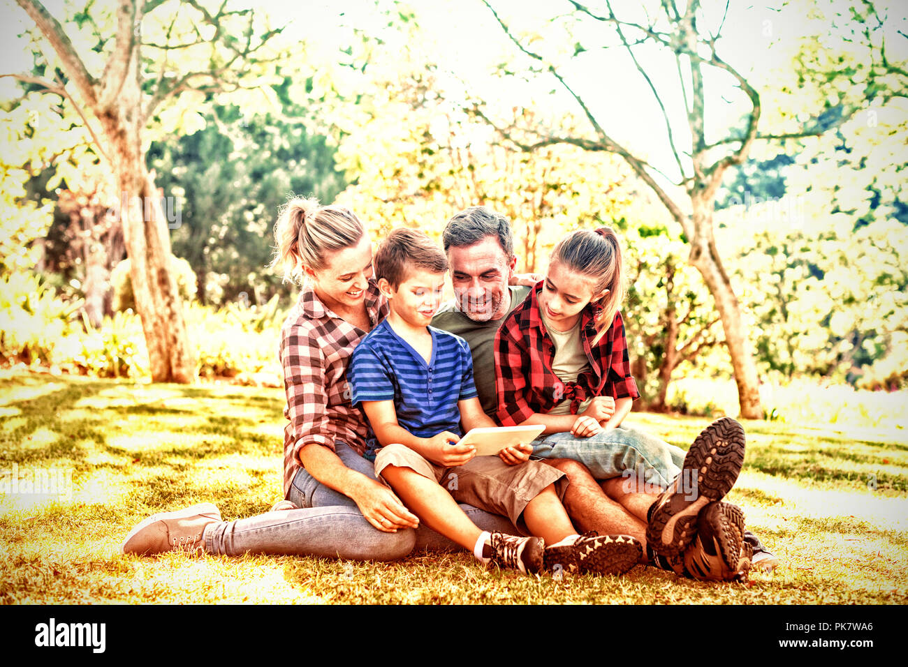 Family using digital tablet in the park Stock Photo