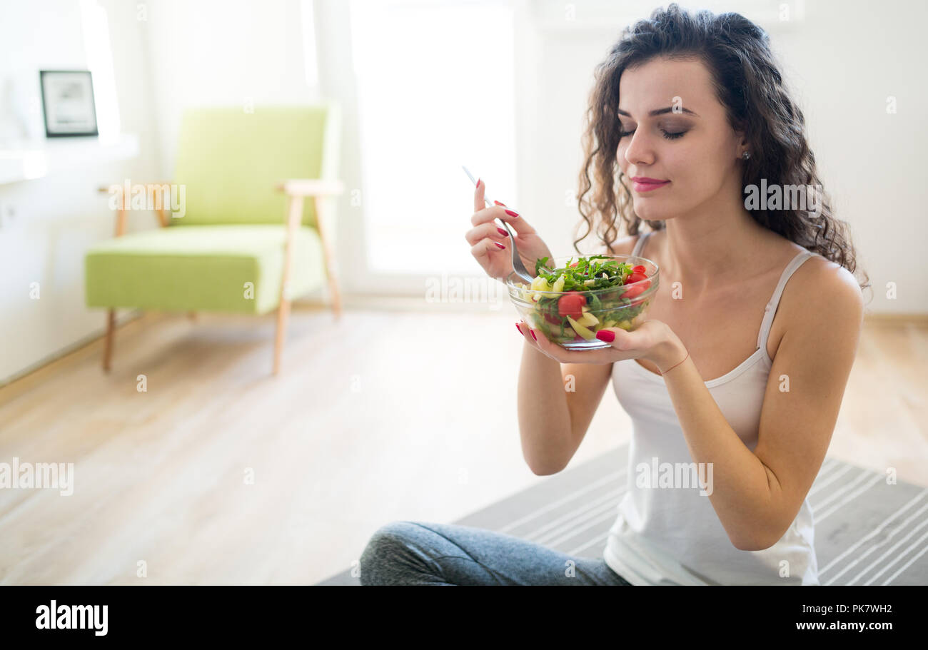 Fitness woman eating healthy food after workout Stock Photo