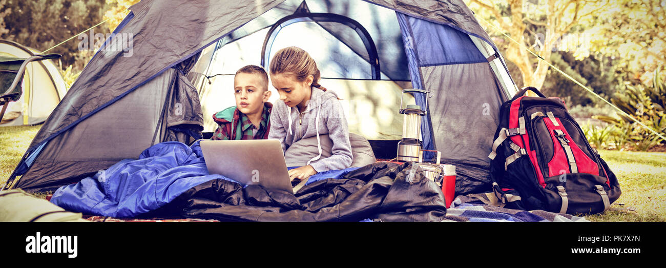 Kids using laptop in the tent Stock Photo - Alamy