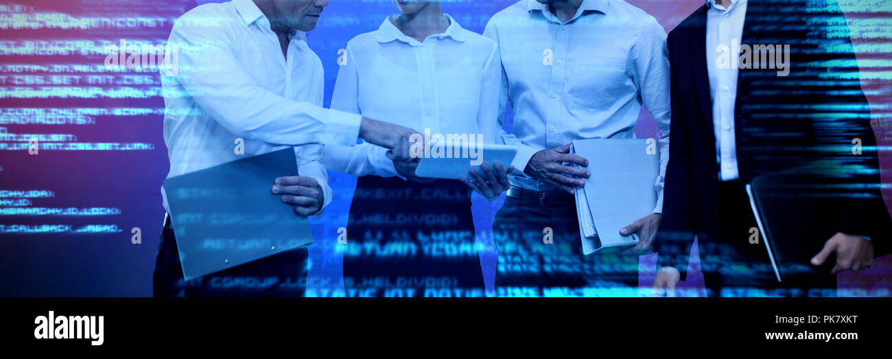 Composite image of business people holding files discussing over tablet Stock Photo