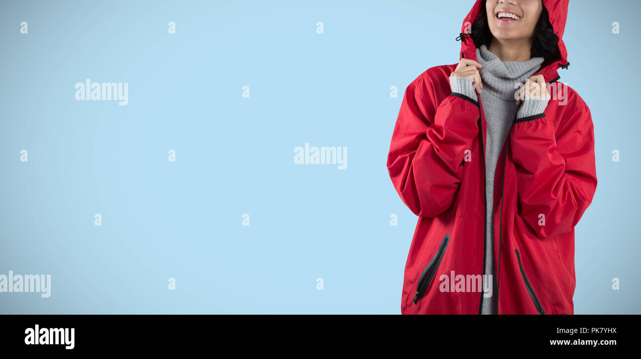 Composite image of woman in hooded jacket standing against white background Stock Photo