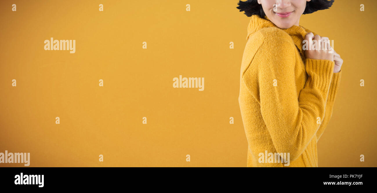 Composite image of woman in winter clothing posing against white background Stock Photo