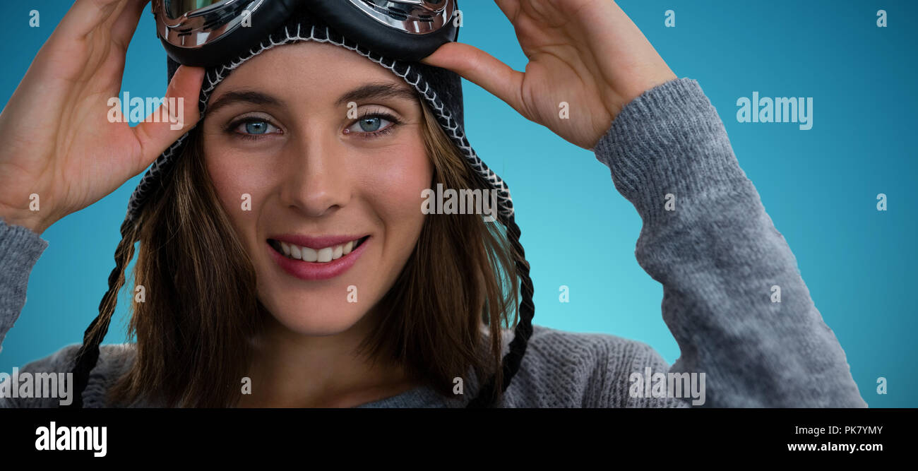Composite image of portrait of woman with ski goggles Stock Photo