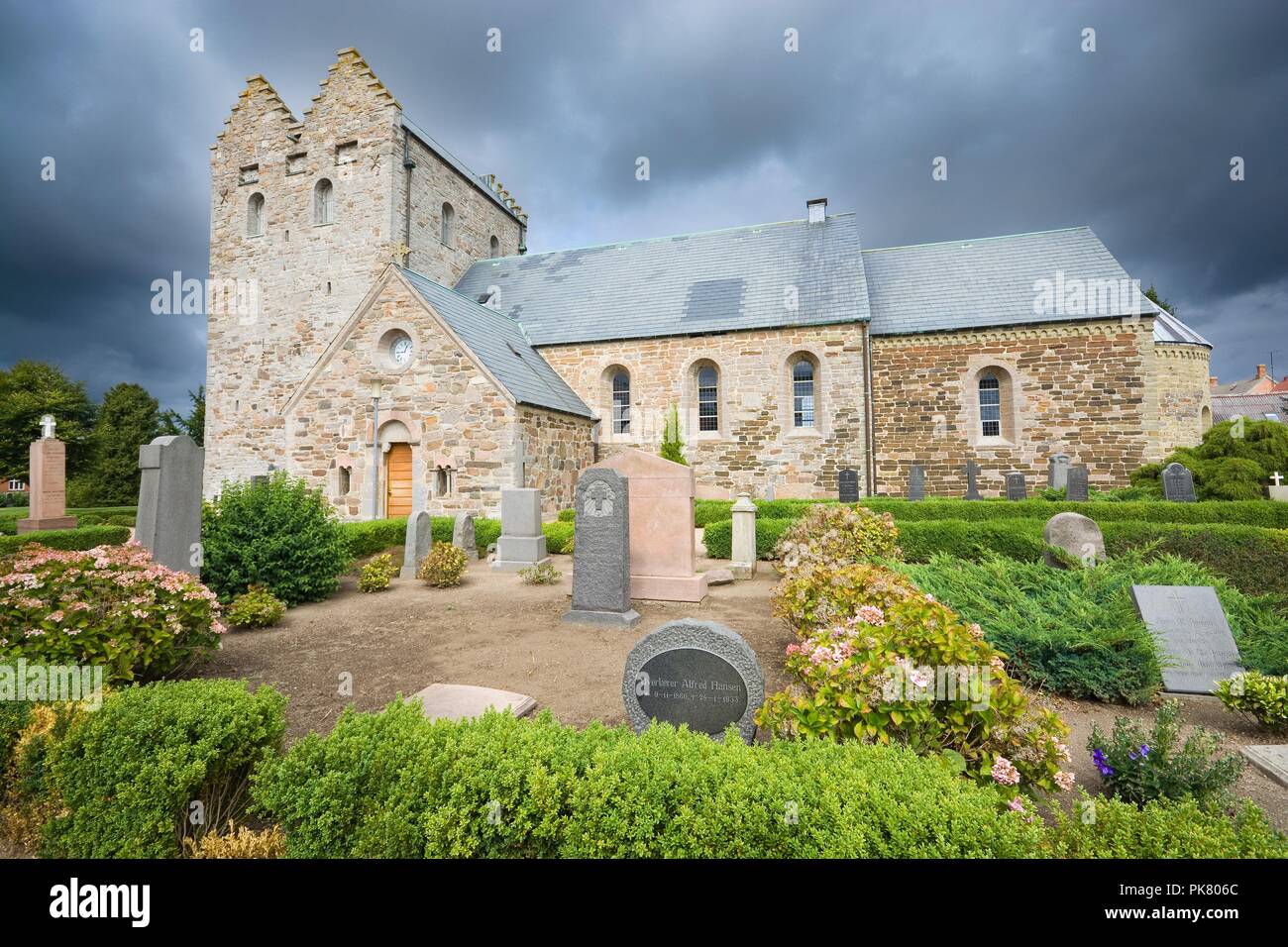 AAKIRKEBY, DENMARK - AUGUST 19, 2018: Aa church against cloudy sky. It is the biggest and oldest church on the Bornholm island. The church was constru Stock Photo