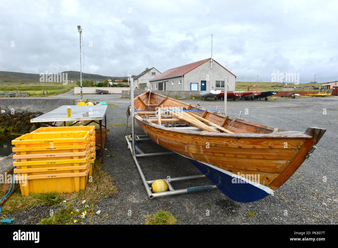 Baltasound boating club and marina on the island of Unst in the Shetland Islands with boats parked outside. Stock Photo