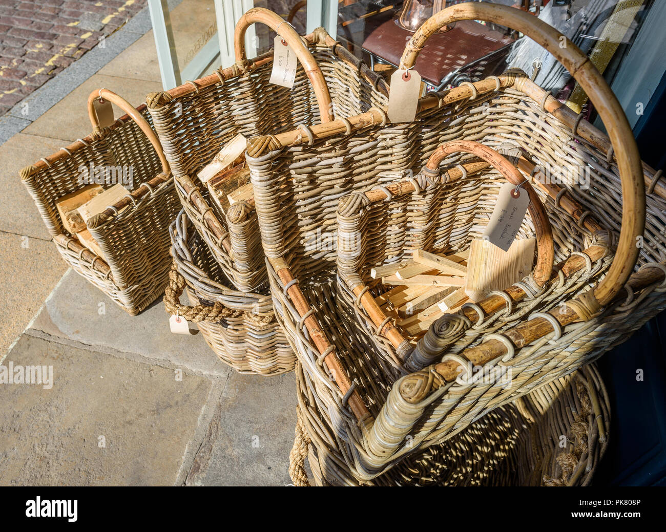 Wicker log baskets for sale outside a shop. Stock Photo