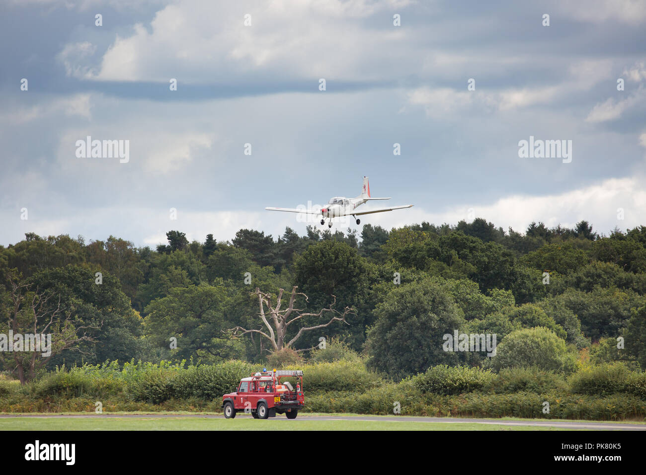 Landscape shot of a light aircraft, in the sky, coming in to land, UK. Stock Photo