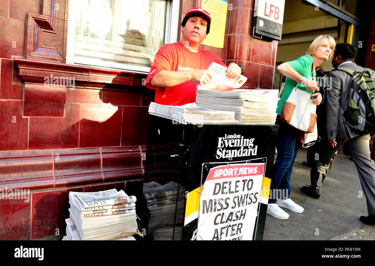 Distributor of the free London Evening Standard newspaper outside a tube station, London, England, UK. Stock Photo