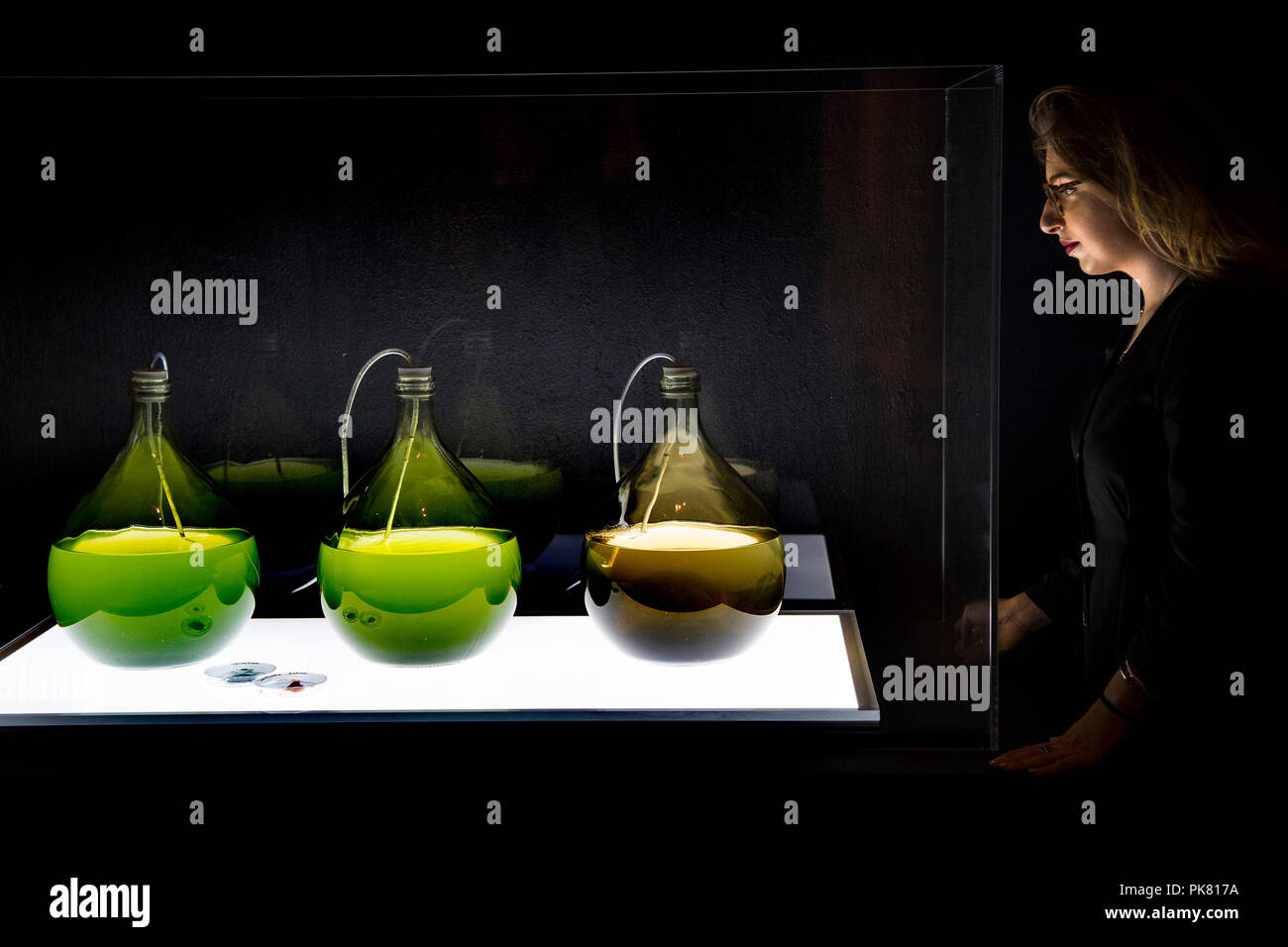 Jars of algae are harvested as a replacement for plastics within the 'A Factory Line that 3D prints in Algae' design during a media preview of the Beazley Designs of the Year, an annual celebration of the most innovative and impactful products and concepts, at the Design Museum in London. Stock Photo